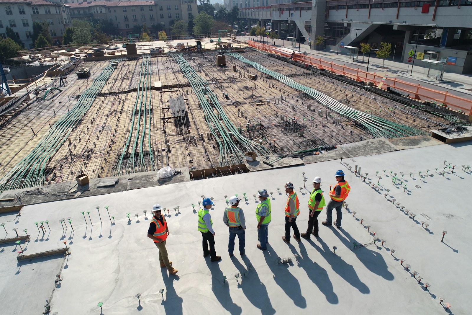 Construction crew in high-visibility gear using business radios