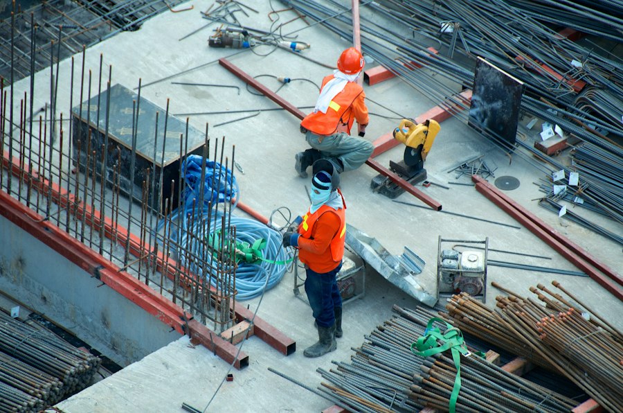 Construction workers in high-visibility gear on a job site