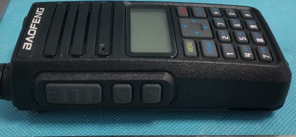 DM-1801 Pro from the side, showing the PTT and side keys